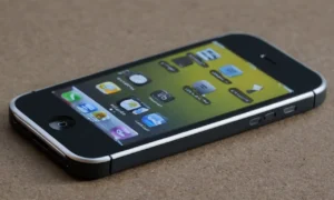 Un primer plano del iPhone original 2007 con su icónica pantalla multi-touch y diseño elegante.